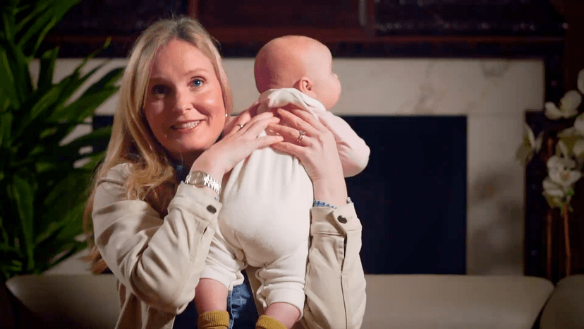 Marlene smiling for the camera with her newborn daughter