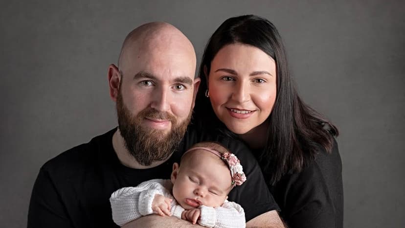 Family photograph of Adam, Laura, and Aria Rose