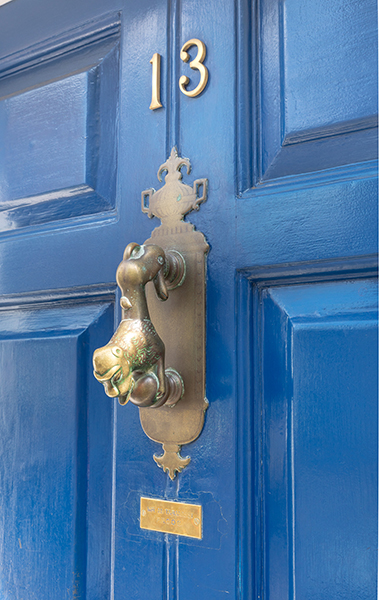 Close up of blue door and knocker on our prices page